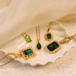 Gold necklaces set with emerald green zircon teardrop and rectangular pendants