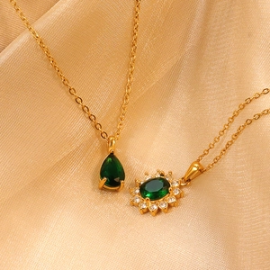 Gold layered necklace featuring emerald green pear drop and floral zircon pendants