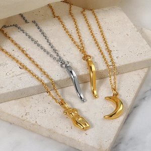 Minimalist gold and silver titanium necklaces with moon and crescent horn charms