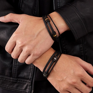Detail of multi-layer braided leather bracelet with gold and silver metal clasps