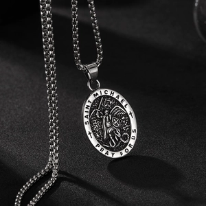 Macro shot of vintage Saint Michael archangel embossed pendant on a steel chain necklace