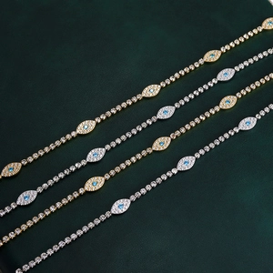 Close-up of gold and silver tennis bracelets with micro-pave evil eye charms