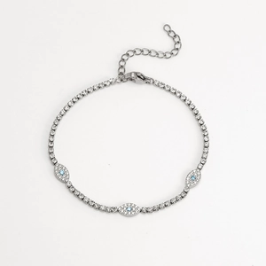 Silver evil eye bracelet with pavé-set zircons and blue gemstones on a white background