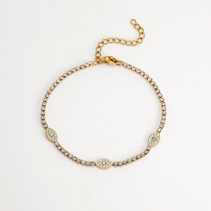 Gold tennis bracelet featuring clear zircons and blue Evil Eye charms with lobster clasp