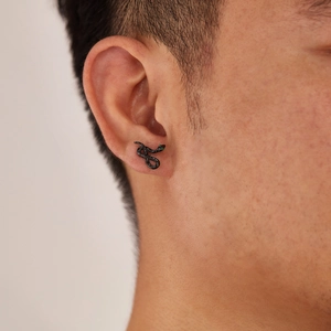 Black snake stud earring in stainless steel with green crystal eye on male ear