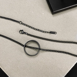 Detail of minimalist black curb chain necklace showing lobster clasp and K14 metal tag