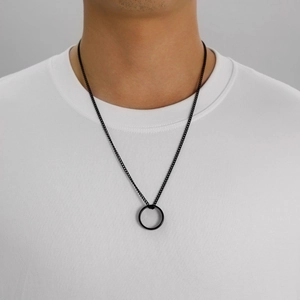 Minimalist black stainless steel ring necklace for men on a white t-shirt