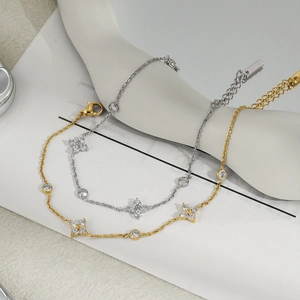 Macro detail of stainless steel clover bracelets with zircon in gold and silver finish