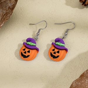 Detail of Halloween pumpkin earrings with purple wizard hats and orange resin finish