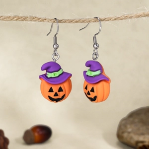 Halloween pumpkin earrings with purple witch hat on rustic rope background