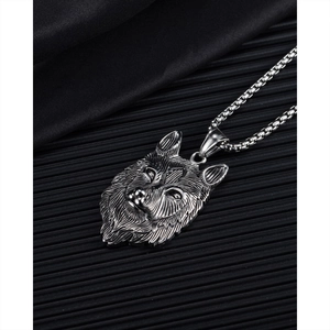 Detailopname van vintage zilveren wolfskop hanger met Noords symbool aan een metalen ketting