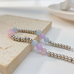 Detail of stainless steel bead bracelet with faceted natural morganite stones