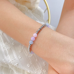Detailed macro view of beaded bracelet with silver metal and faceted pastel morganite stones