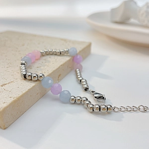 Detail of beaded bracelet with pastel natural stones and stainless steel lobster clasp