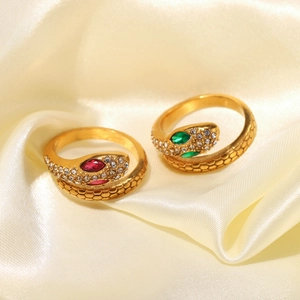 18K gold plated snake rings with red and green stones on elegant beige silk background