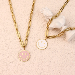 Minimalist smiley face pendant necklaces in gold plating with pink and white enamel