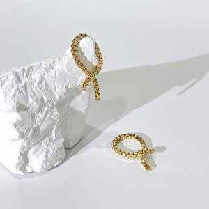 Elegante goldene Box-Ketten-Ohrstecker mit geometrischem Ringdesign auf weißem Stein