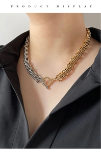 Detail einer zweifarbigen gold-silber geflochtenen Kette mit stylischem OT-Knebelverschluss