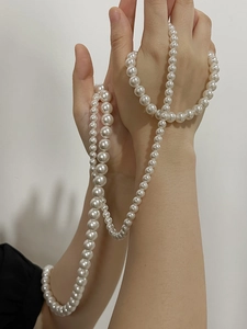 Detail of long elegant pearl necklace wrapped multiple times showing lustrous round white pearls
