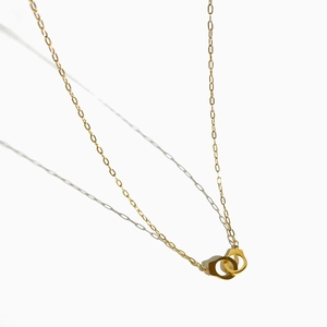 Minimalist 18K gold plated stainless steel necklace featuring interlocking handcuff pendants