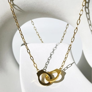 Minimalist 18K gold-plated stainless steel necklace featuring interlocking handcuff pendants
