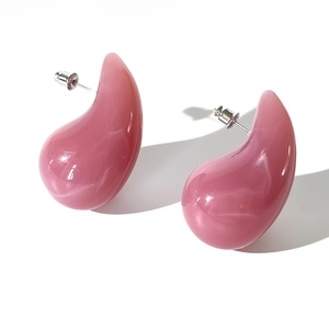 Close-up of pink marbled acrylic teardrop earrings with silver-tone metal studs