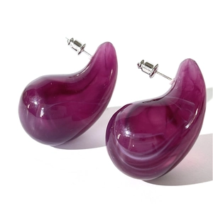 Macro detail of purple waterdrop acrylic earrings with marble texture and metal posts