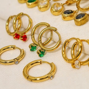 18K gold plated hoop earrings set with colorful zircon pendants on white fabric
