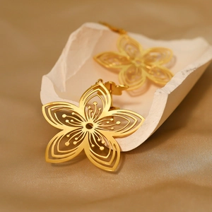 Elegant 18K gold-plated titanium steel hollow floral earrings with intricate petal design
