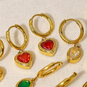 Detailed macro view of 18K gold-plated hoops with colorful heart and oval zircon pendants