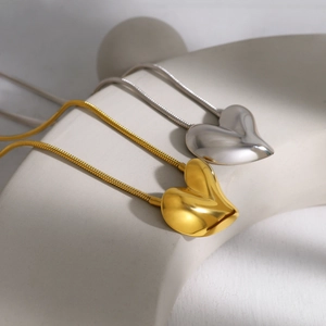 Gepolijste hartvormige hangers in goud en zilver met een fijne slangenketting