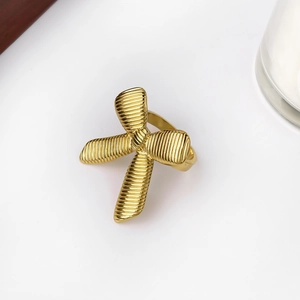 Macro shot of gold bow ring featuring detailed vertical ribbed texture and polished finish