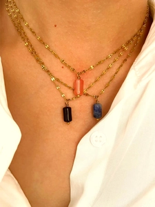 Close-up of three colorful cylinder natural stone pendants on gold stainless steel chains