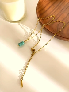 Detail of waterproof gold chain with turquoise stone pendant and adjustable lobster clasp