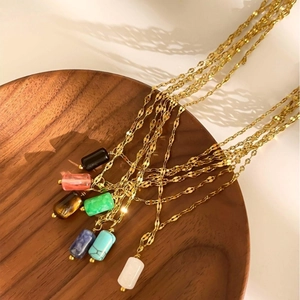 Colorful natural stone pendant necklaces on gold stainless steel chain in rustic setup