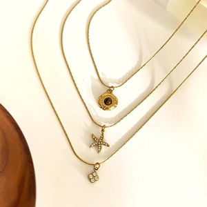 Three-layer gold stainless steel necklace with sun, starfish, and flower pendants