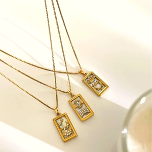 Three vintage tarot card pendant necklaces with sun, moon, and crown shell inlay