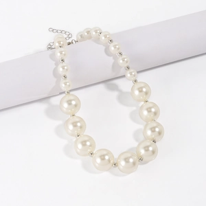 Detail of white faux pearl choker with gradient size beads and lobster clasp closure