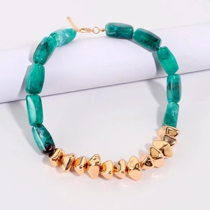 Detailed view of turquoise marble resin blocks and irregular gold beads on necklace
