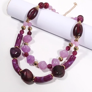 Double-layered chunky beaded necklace in purple and burgundy with gold accents