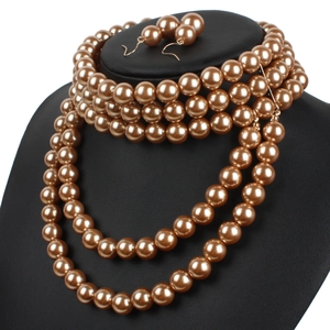 Detail view of multi-layered champagne faux pearl necklace and matching earrings set