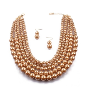 Close-up of multi-layer champagne faux pearl necklace and matching earrings set