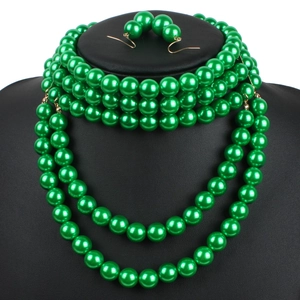 Elegant emerald green multi-layer faux pearl necklace and earring jewelry set on display