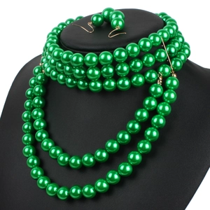 Detail of multi-layer long green pearl necklace set on a professional black mannequin stand