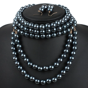 Detail of elegant multi-layer dark grey faux pearl necklace set and matching earrings