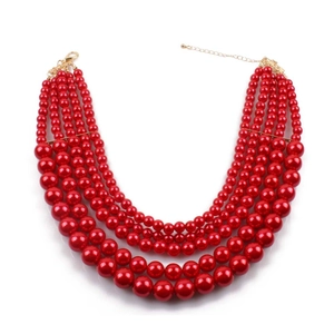 Detail view of a 5-layer red faux pearl tiered necklace with gold plated lobster clasp