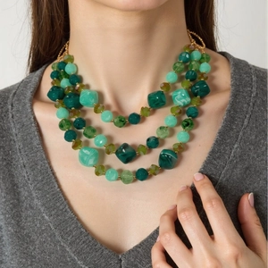 Collier multi-rangs en résine verte avec perles de formes variées sur mannequin