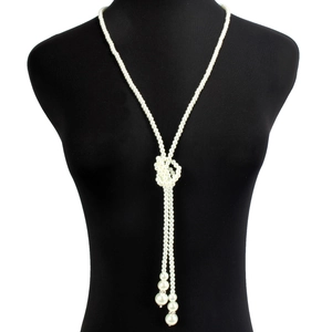 Close-up of vintage multi-layer pearl necklace with a knotted tassel and crystal accents