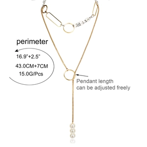 Minimalist silver and gold layered necklace with circular rings and white faux pearls