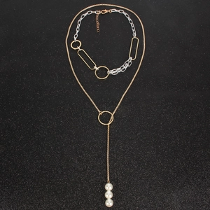 Layered gold and silver chain necklace with elegant vertical white pearl pendants